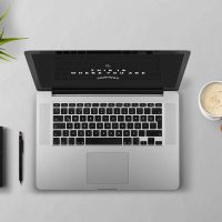 Laptop, coffee, arm — Treating the Whole Person: The Holistic Philosophy of Dr Ian Weisberg Niceville Florida